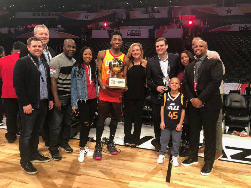 Coaches and staff of the Utah Jazz celebrate with Donovan Mitchell